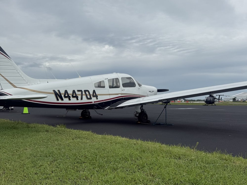 N44704 on the ramp at KPIE with helicopters in the background