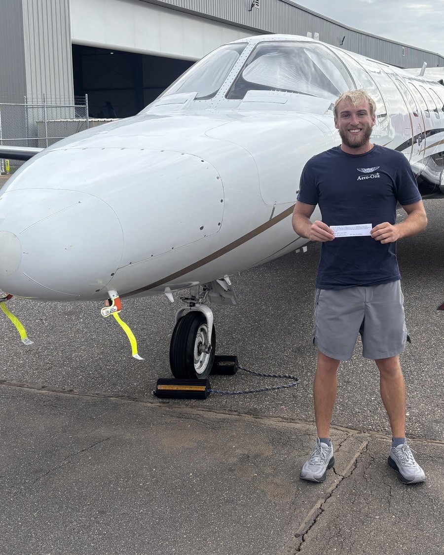 Gavin Curfiss standing in front of a King Air on the ramp at KPIE