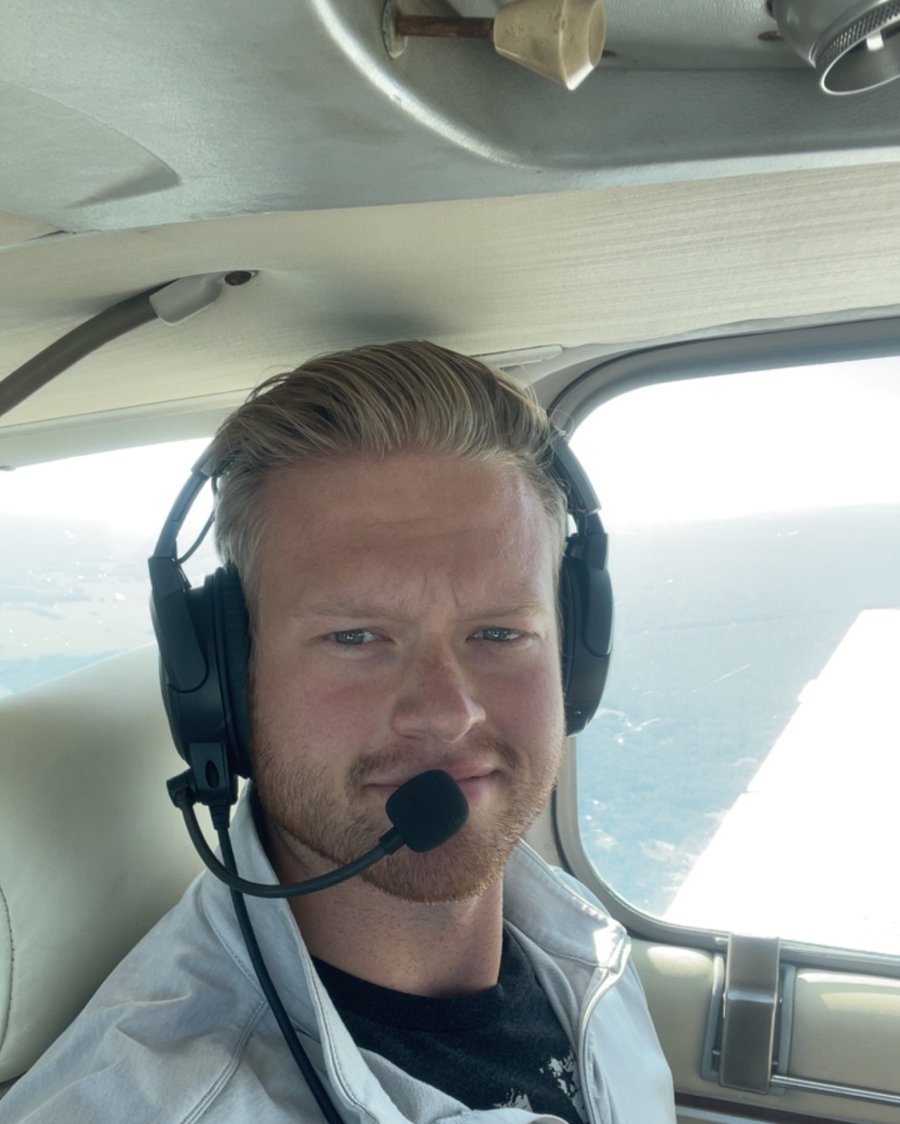 Lars Talsness in the cockpit wearing a headset